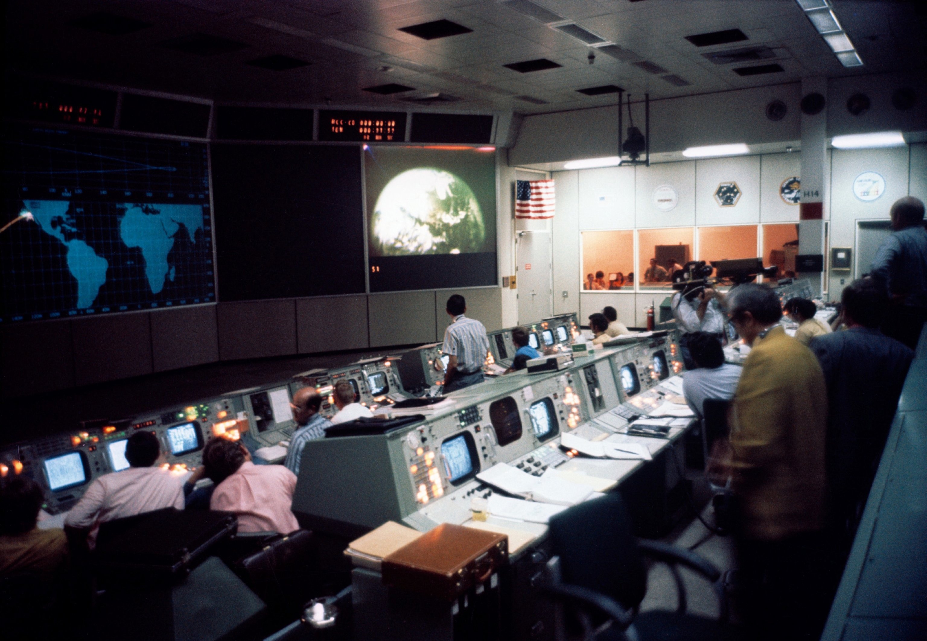 Flight controllers at their consoles in NASA Mission Control during Apollo 16, monitoring a system in operation